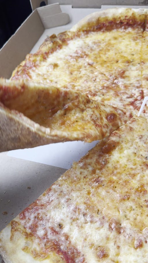 Pizza slices on plates beside Italian comfort food.