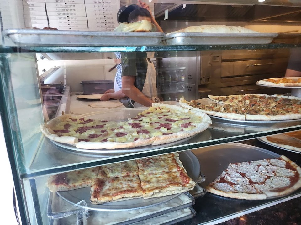 Old-school storefront with a simple pizza counter.